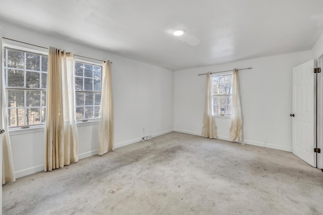 empty room featuring carpet floors and baseboards