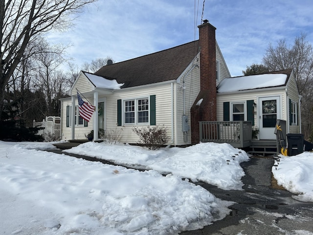 view of snow covered exterior featuring a chimney