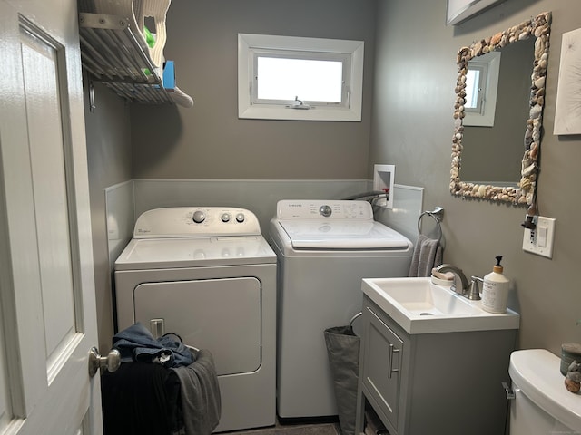 laundry room featuring laundry area, a sink, and independent washer and dryer