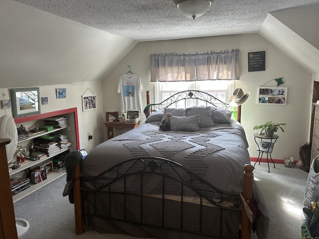 carpeted bedroom with a textured ceiling and vaulted ceiling