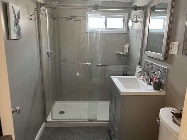 full bath with a stall shower, vanity, toilet, and tile patterned floors