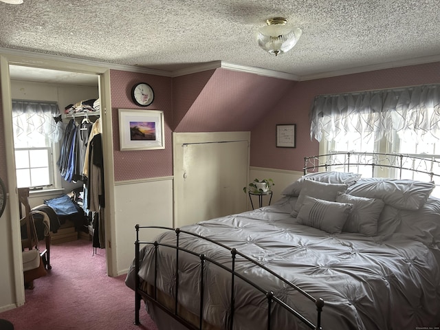 bedroom with carpet, a closet, ornamental molding, and a textured ceiling