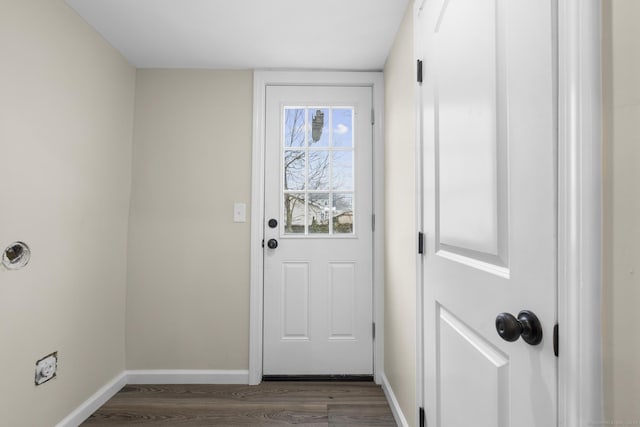 doorway to outside featuring dark wood-style flooring and baseboards