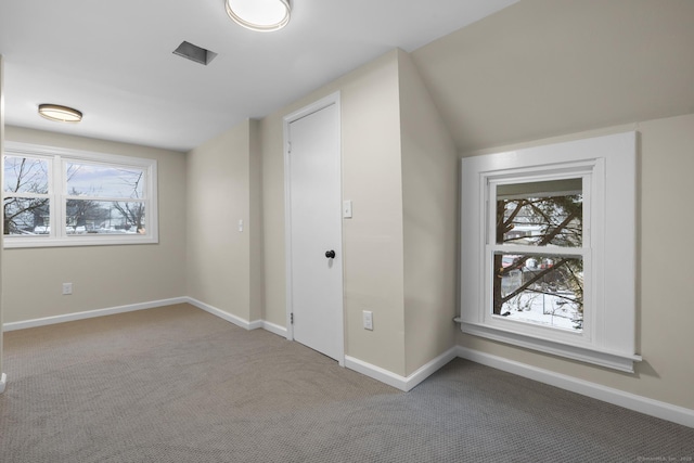 bonus room with carpet floors and baseboards