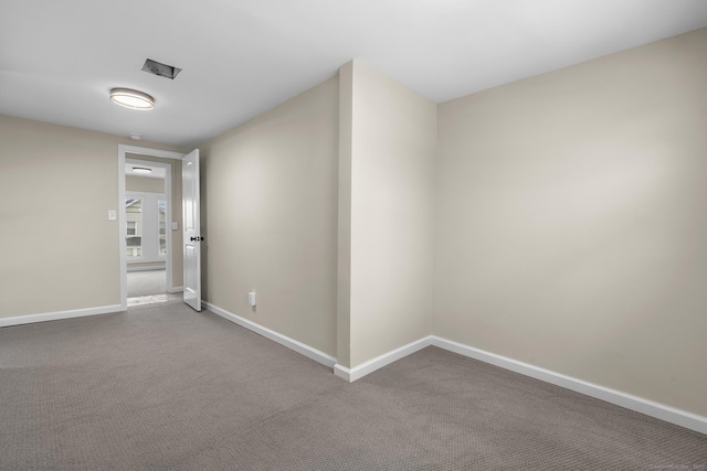 unfurnished room with carpet floors and baseboards