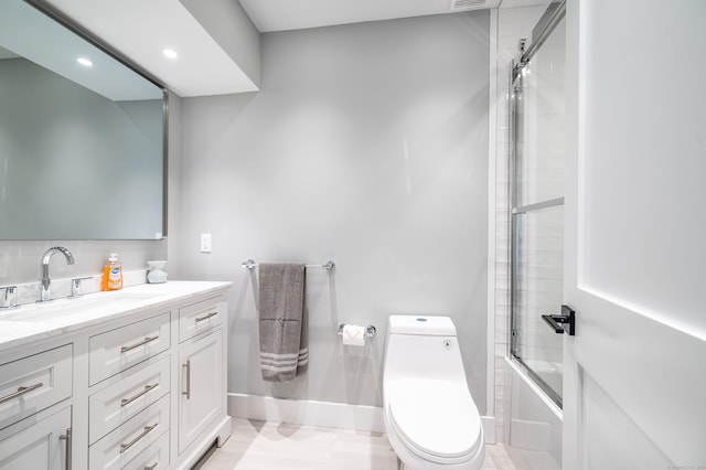 bathroom featuring bath / shower combo with glass door, visible vents, toilet, vanity, and baseboards