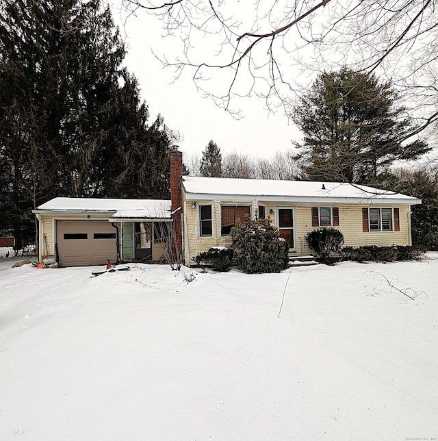 manufactured / mobile home featuring a chimney and an attached garage