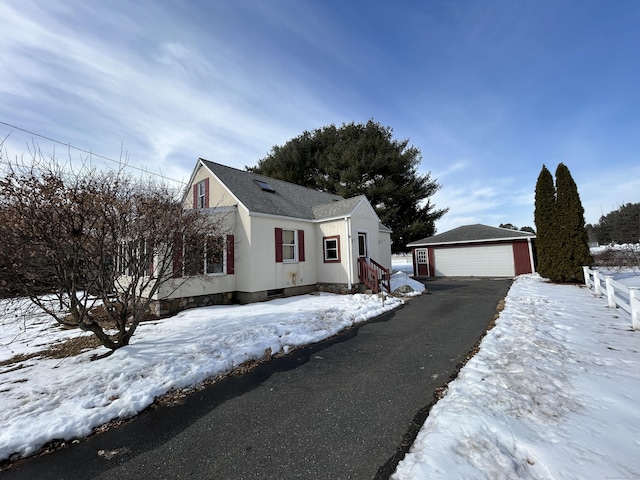 view of front of house featuring an outdoor structure and a detached garage