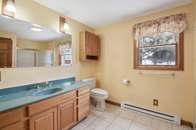 bathroom featuring a baseboard radiator, vanity, baseboards, tile patterned floors, and a stall shower