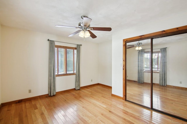 unfurnished bedroom featuring baseboards, ceiling fan, and light wood-style floors