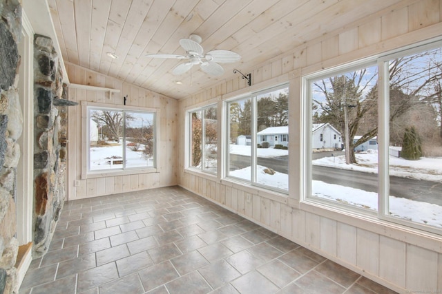 unfurnished sunroom with vaulted ceiling, ceiling fan, and wooden ceiling