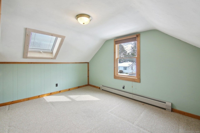 bonus room featuring vaulted ceiling, carpet floors, a baseboard radiator, and baseboards