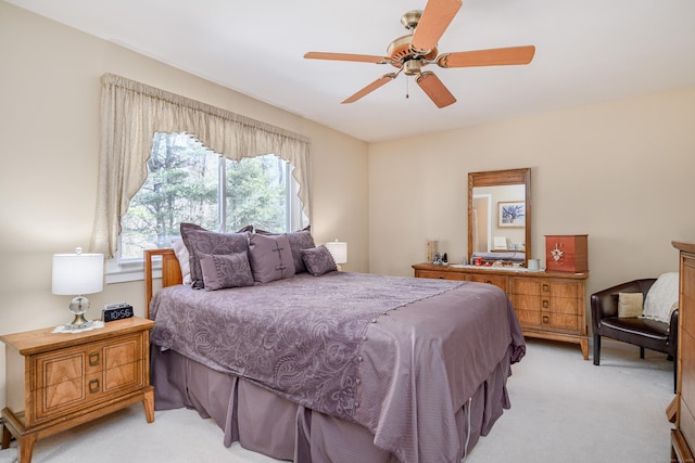 bedroom with light carpet and a ceiling fan