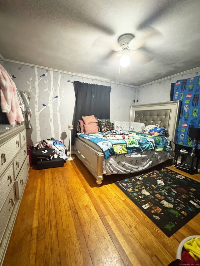 bedroom with light wood-style flooring and a ceiling fan