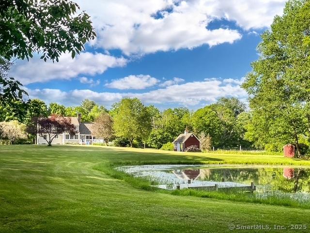 view of property's community with a water view and a yard