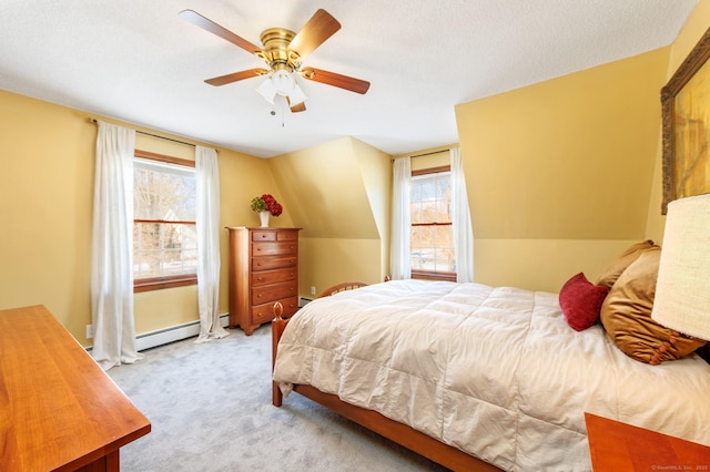 carpeted bedroom featuring vaulted ceiling, ceiling fan, multiple windows, and baseboard heating