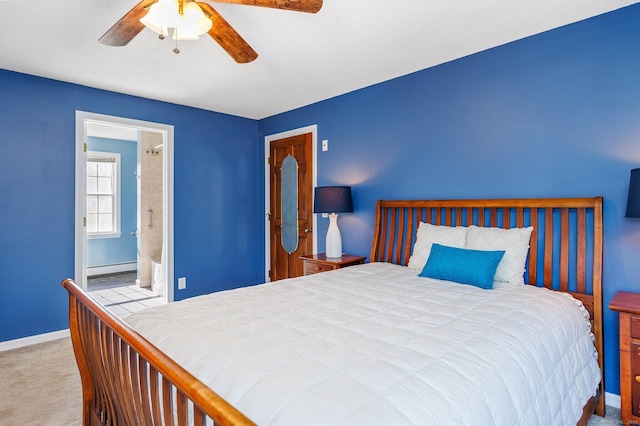 carpeted bedroom with a baseboard heating unit, connected bathroom, a ceiling fan, and baseboards