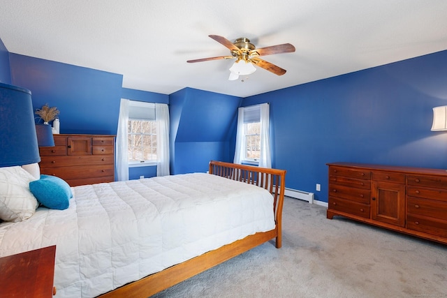 carpeted bedroom with baseboard heating, a ceiling fan, and baseboards