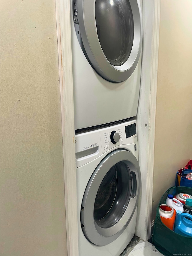 washroom with laundry area and stacked washer / dryer