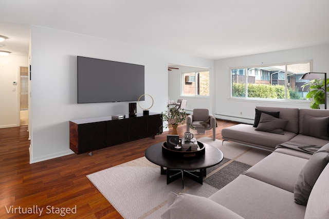 living room with baseboards, baseboard heating, and dark wood-type flooring