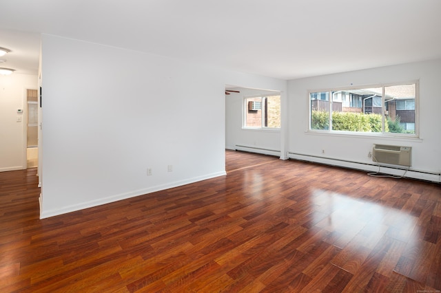 empty room featuring dark wood-style floors and baseboards