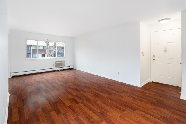 empty room with dark wood-type flooring, a baseboard radiator, baseboards, and a wall mounted AC