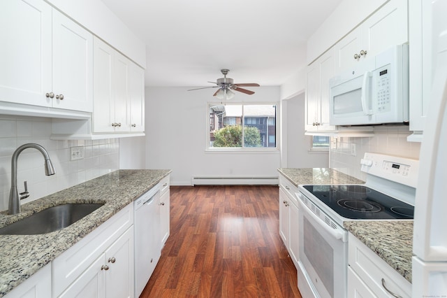 kitchen featuring light stone counters, white appliances, white cabinetry, and a sink