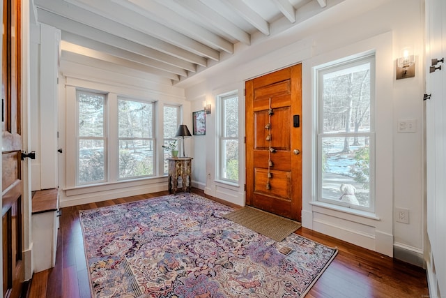 entryway featuring wood-type flooring, beamed ceiling, and baseboards