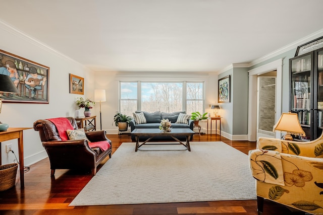 living room featuring baseboards, wood finished floors, and crown molding