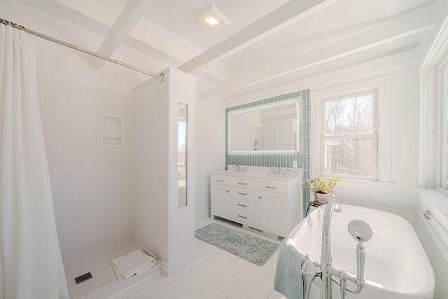 bathroom featuring a shower stall, a bath, and vanity