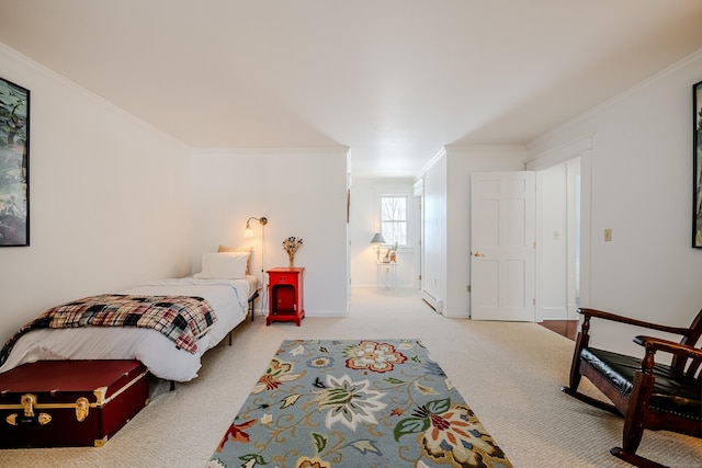 carpeted bedroom with a baseboard radiator, baseboards, and crown molding