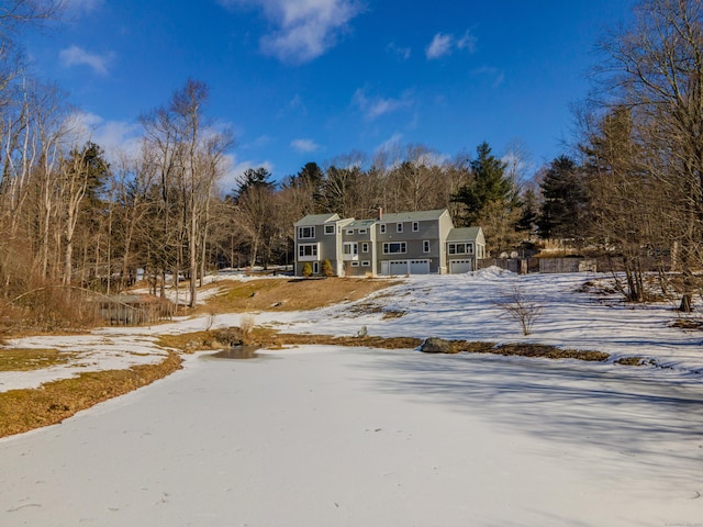 yard covered in snow with driveway