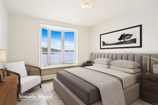 bedroom with a water view, a baseboard heating unit, and tile patterned floors