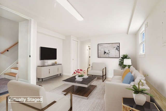 living room featuring stairs and baseboards