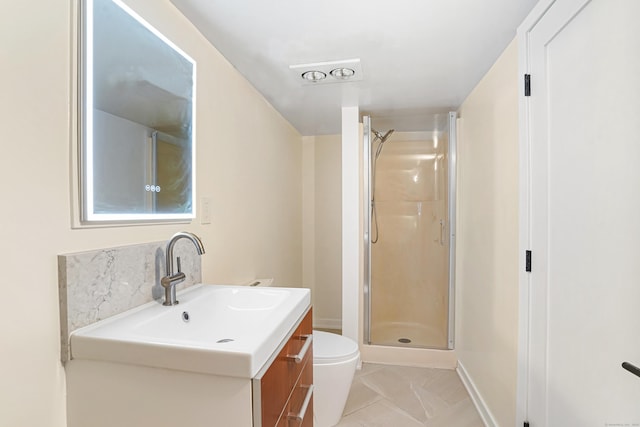 bathroom featuring a stall shower, vanity, toilet, and baseboards