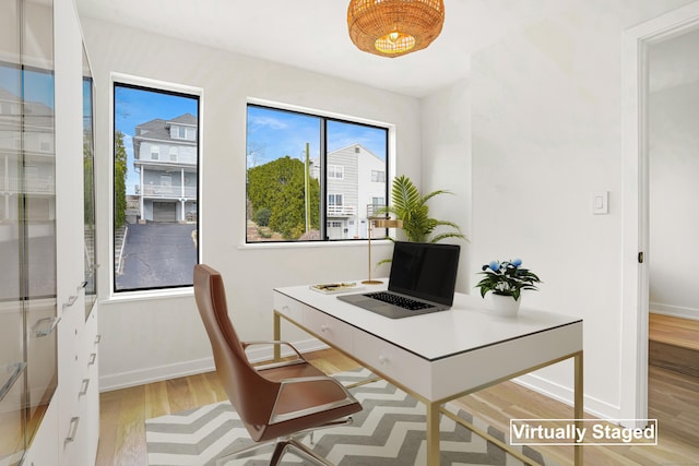 home office featuring light wood-type flooring and baseboards