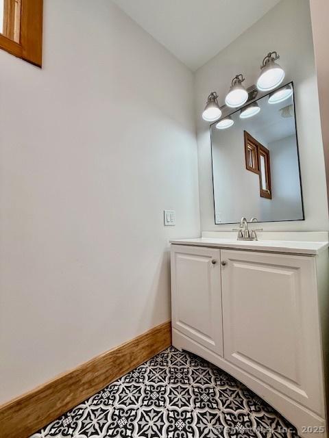 bathroom featuring vanity and baseboards