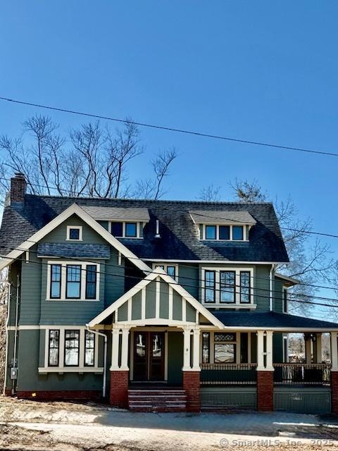 view of front of house with covered porch and a chimney