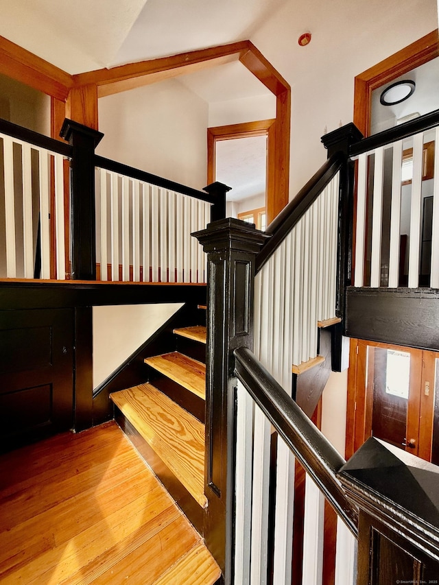 stairs featuring wood finished floors