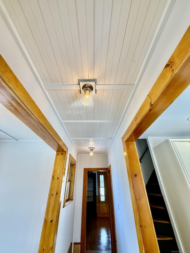 hall featuring stairway, wood finished floors, and wood ceiling