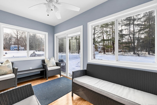 sunroom / solarium with a healthy amount of sunlight and ceiling fan