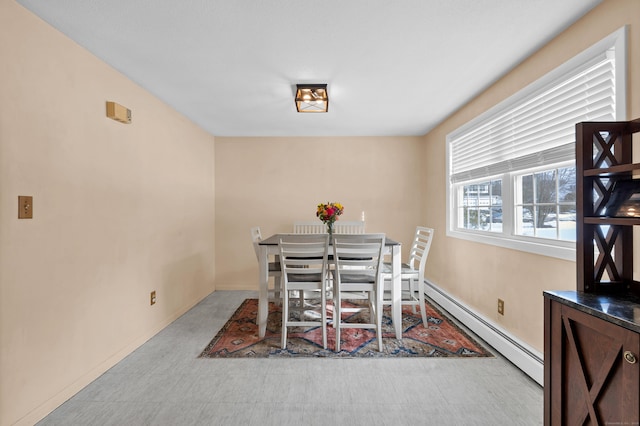 dining area with light floors, baseboards, and baseboard heating