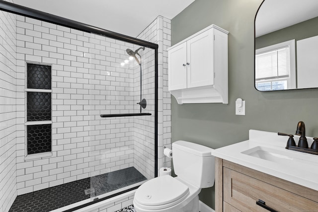 bathroom featuring a stall shower, vanity, and toilet