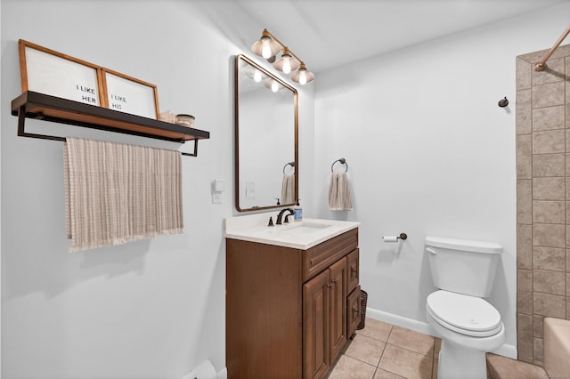 bathroom with tile patterned floors, toilet, vanity, baseboards, and walk in shower