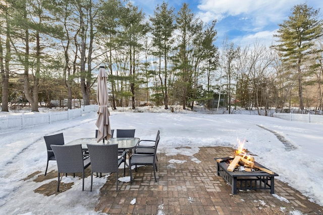 yard layered in snow featuring an outdoor fire pit