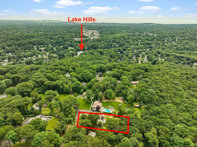 drone / aerial view featuring a wooded view