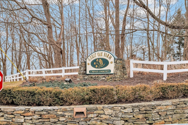 community sign featuring fence