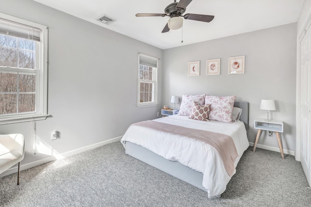 bedroom with multiple windows, carpet, visible vents, and baseboards