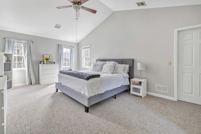 carpeted bedroom with visible vents, vaulted ceiling, and baseboards