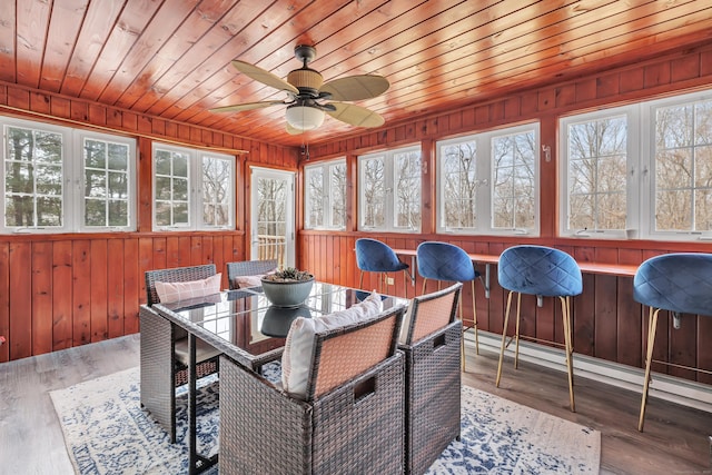 sunroom with wood ceiling and a ceiling fan